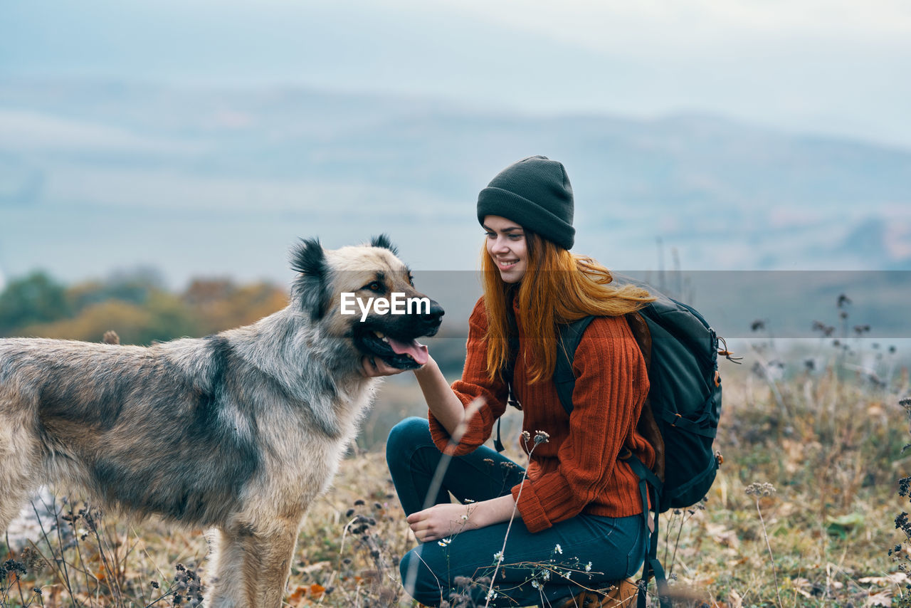 MAN WITH DOG OUTDOORS