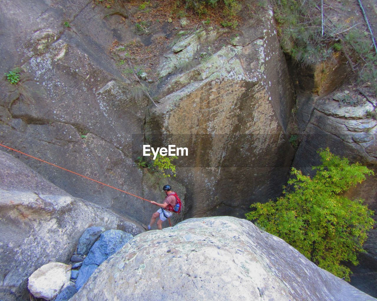 High angle view of senior man rock climbing