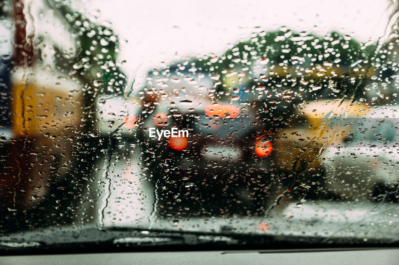 Wet car windshield in rainy season