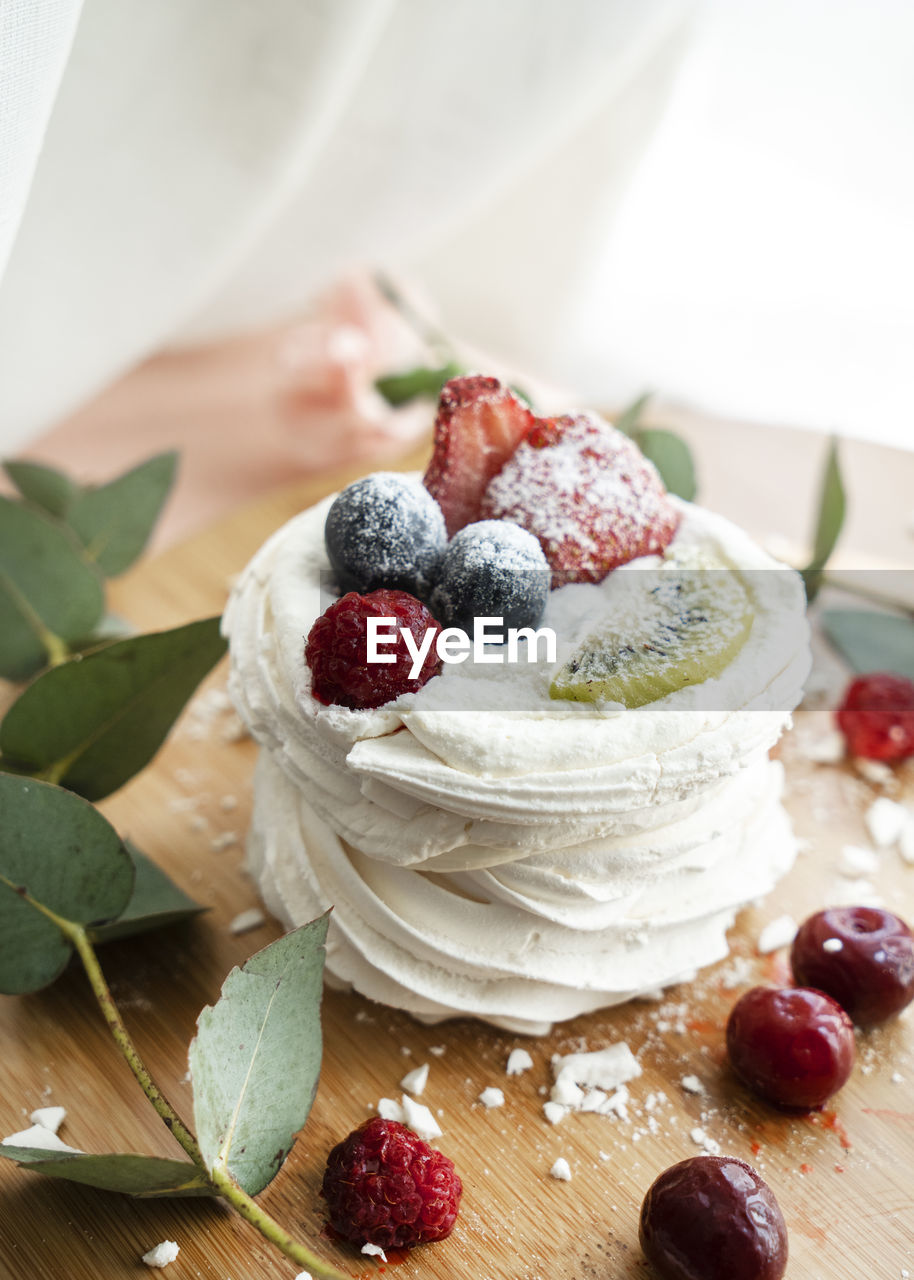 food and drink, food, fruit, berry, sweet food, pavlova, sweet, raspberry, healthy eating, breakfast, dessert, freshness, meal, dish, produce, dairy, berries, birthday cake, plant, blueberry, strawberry, whipped cream, cake, leaf, indoors, wood, blackberry, cream, table, plant part, baked, nature