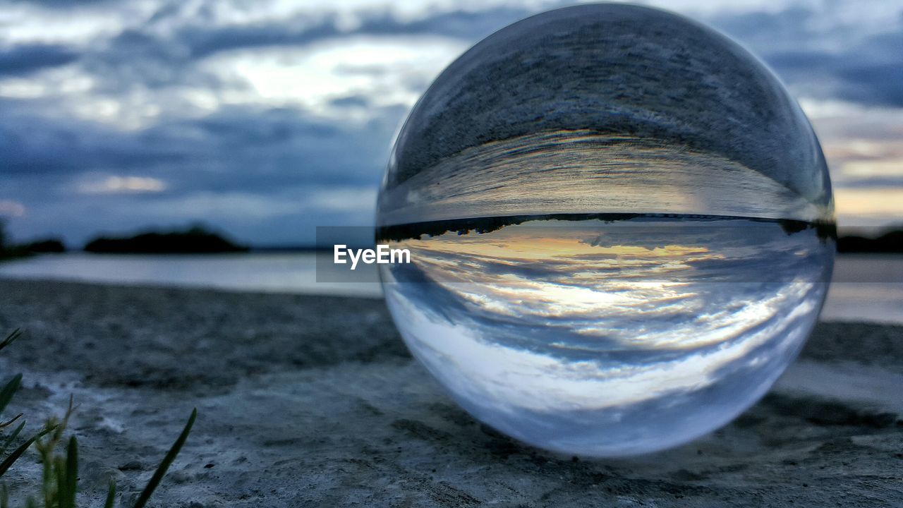 Reflection of river on crystal ball at sunset