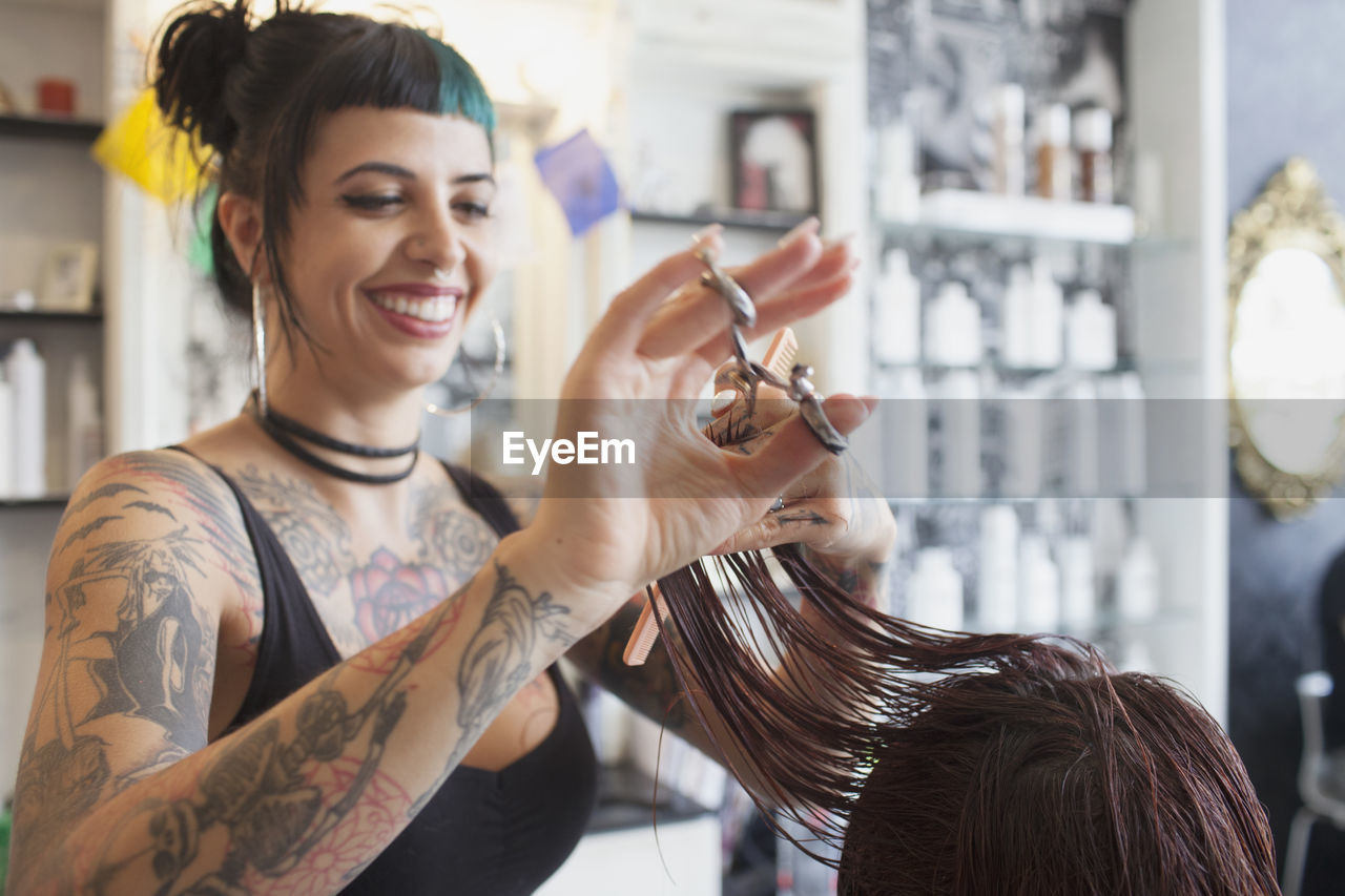 A hair dresser styling a customer's hair.