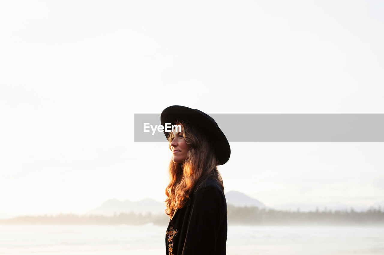 Beautiful, stylish woman on cox bay beach in tofino