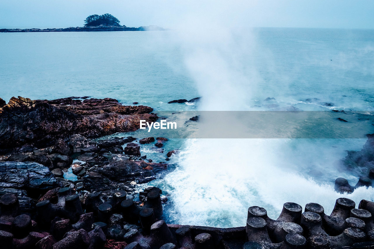 Waves splashing on rocks at shore