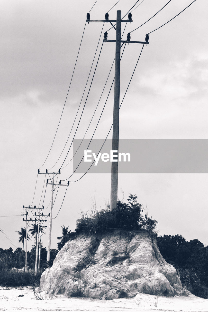 Low angle view of electricity pylon against sky