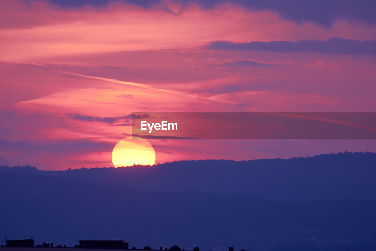 SCENIC VIEW OF SUNSET OVER SILHOUETTE TREES AGAINST SKY