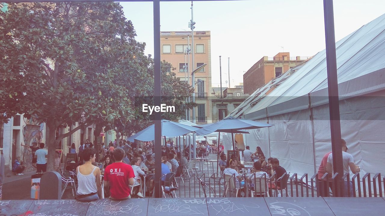 PEOPLE SITTING IN TOWN SQUARE