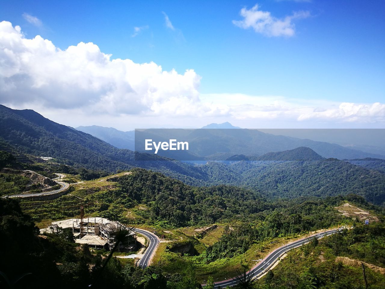 Scenic view of mountains against cloudy sky