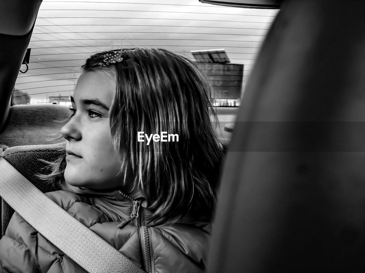 Close-up of thoughtful girl traveling in car