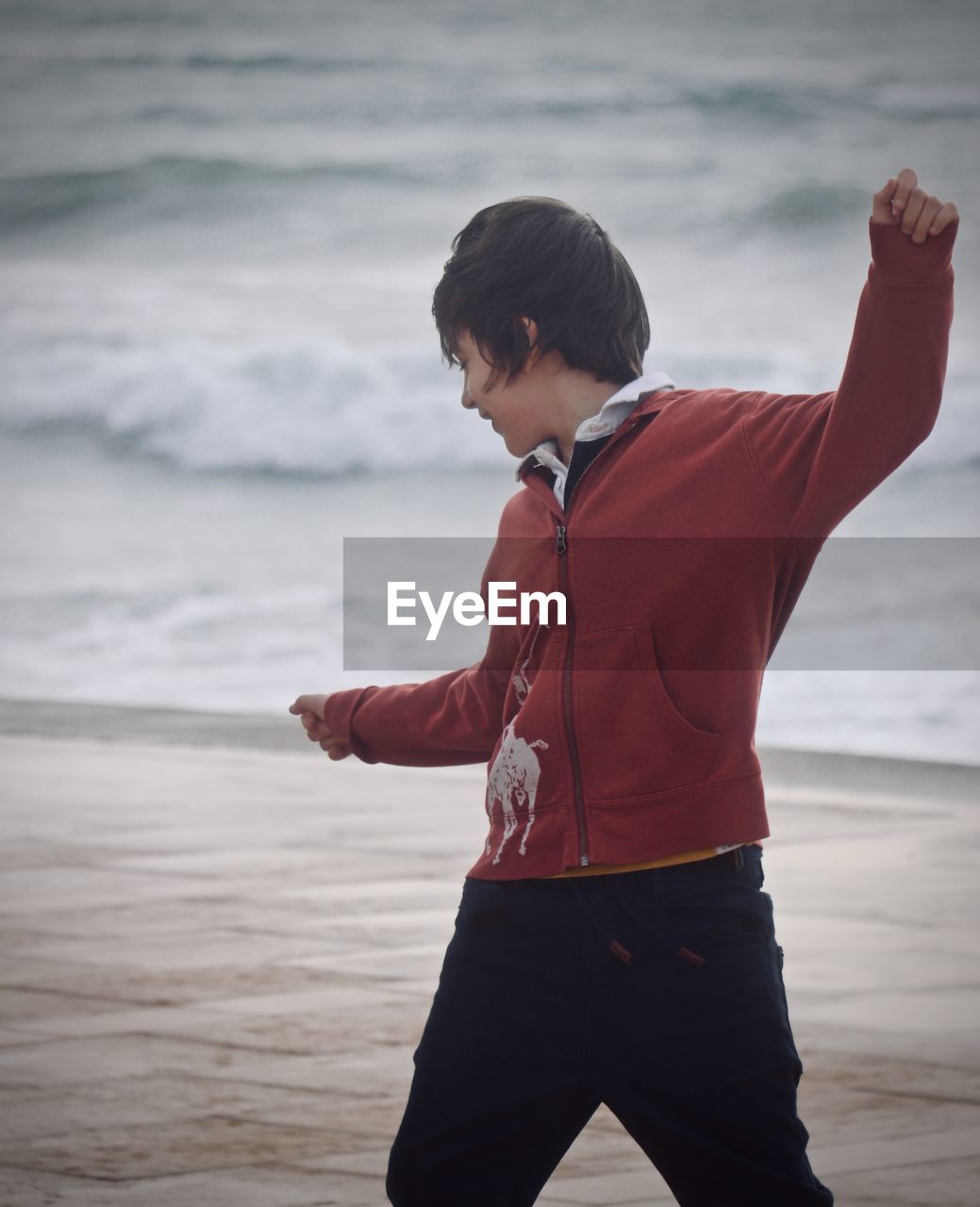 Boy standing against sea