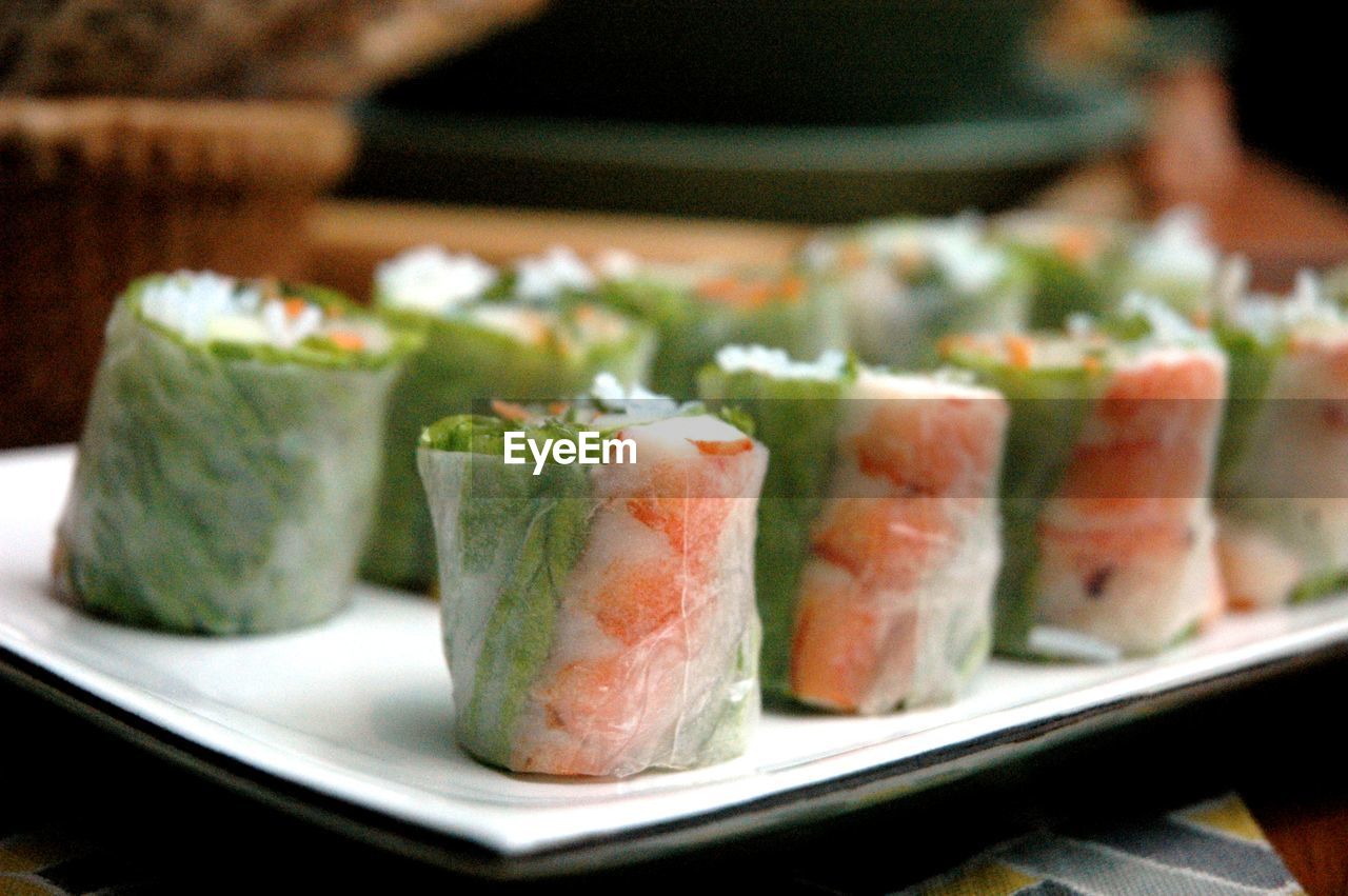 Close-up of fresh spring rolls served on table