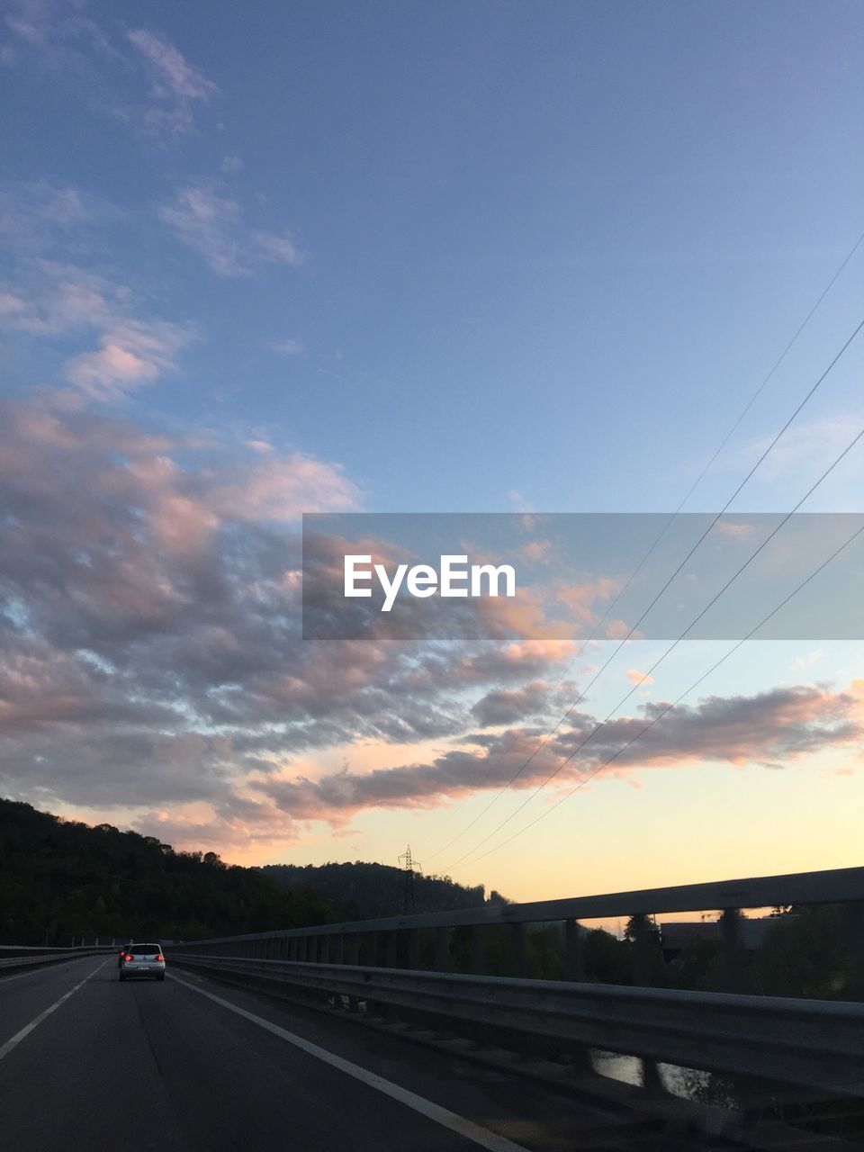 Surface level of empty road against blue sky