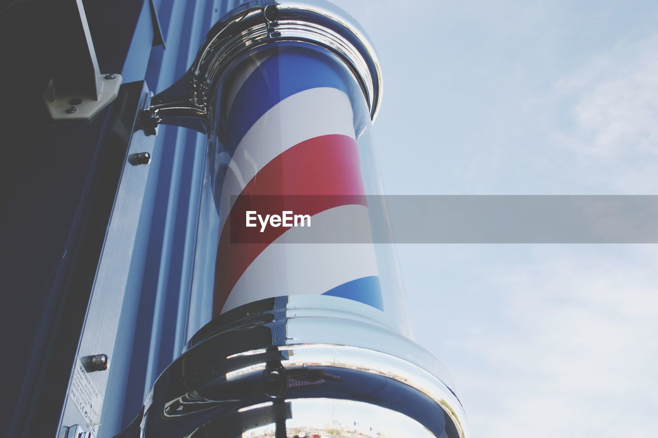 Low angle view of flag against blue sky