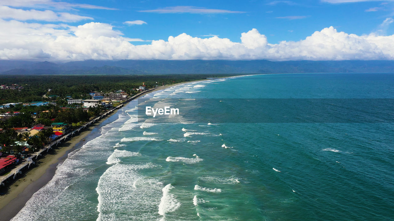 Sandy beach with hotels and tourists, spot of surfing.  sabang beach, baler, aurora, philippines. 