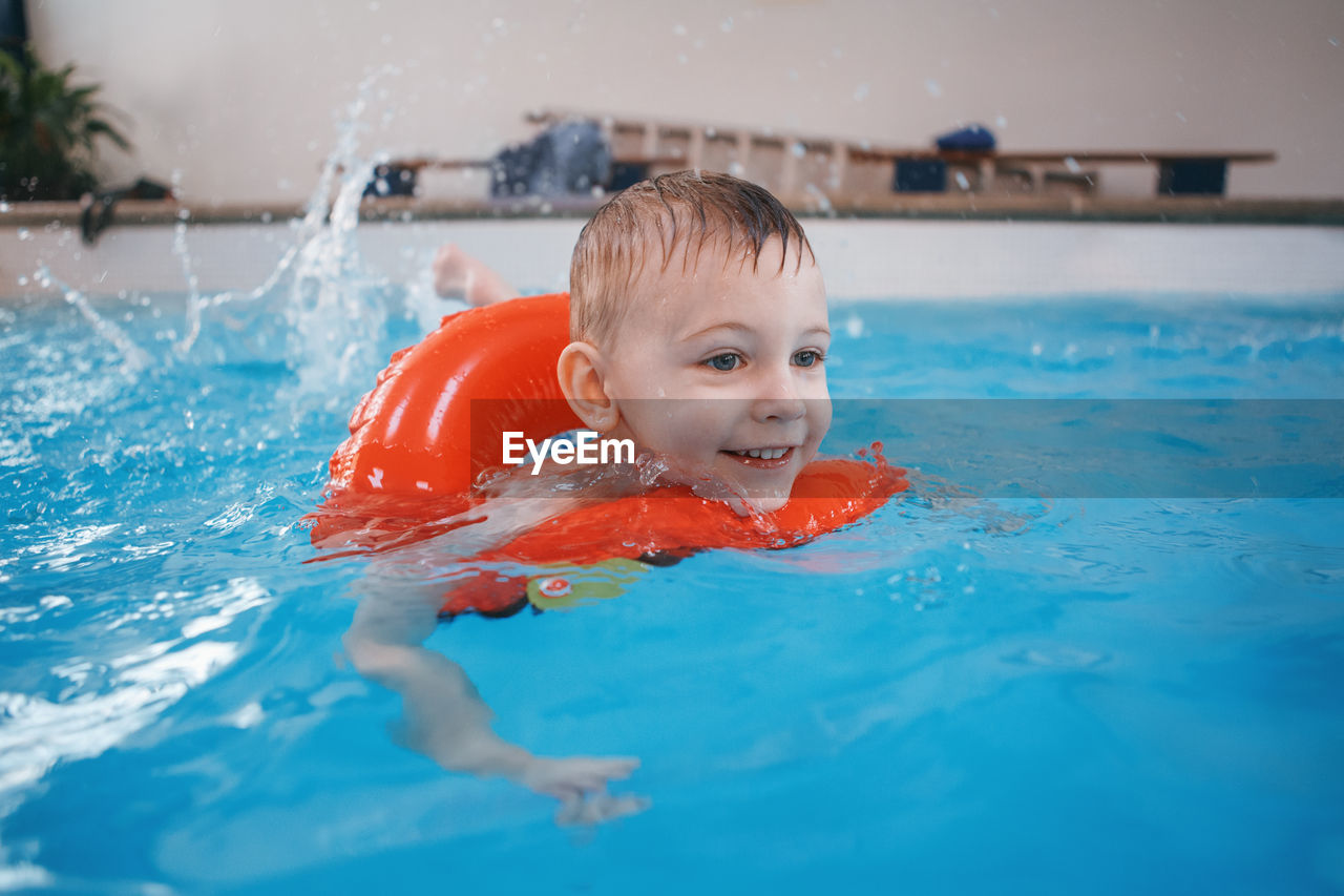 Boy swimming in pool