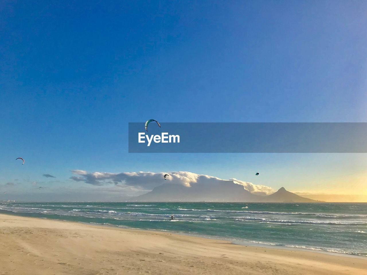 Scenic view of beach against clear blue sky