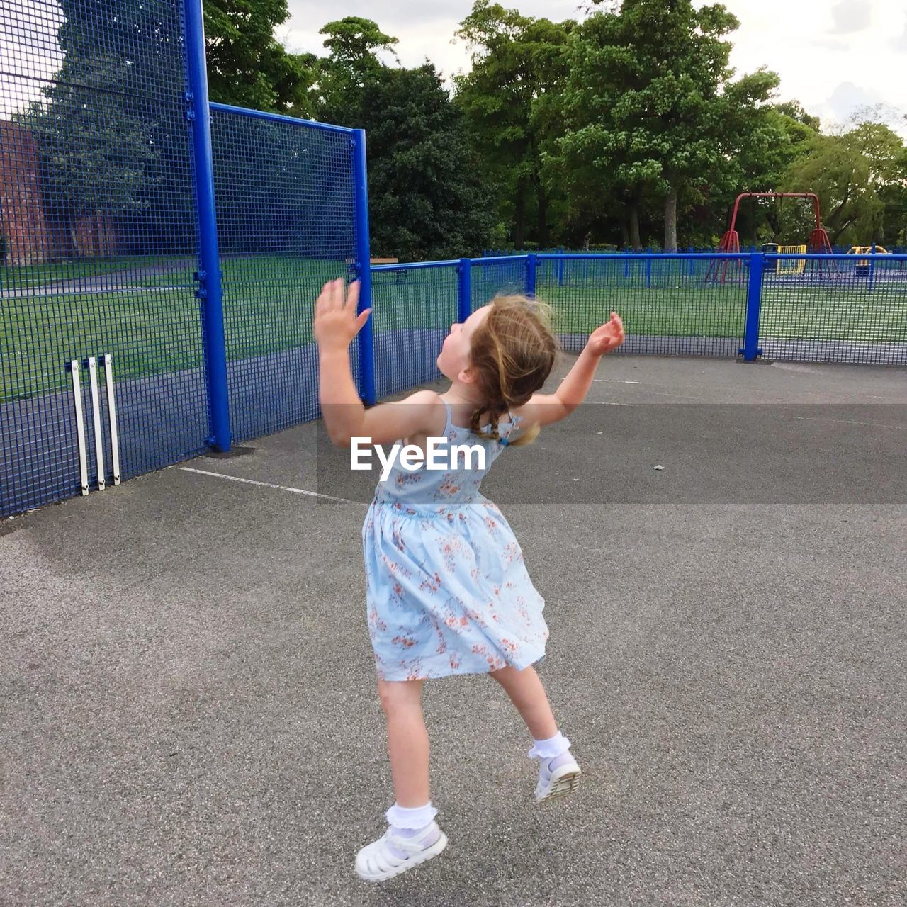 Full length rear view of girl jumping at playground