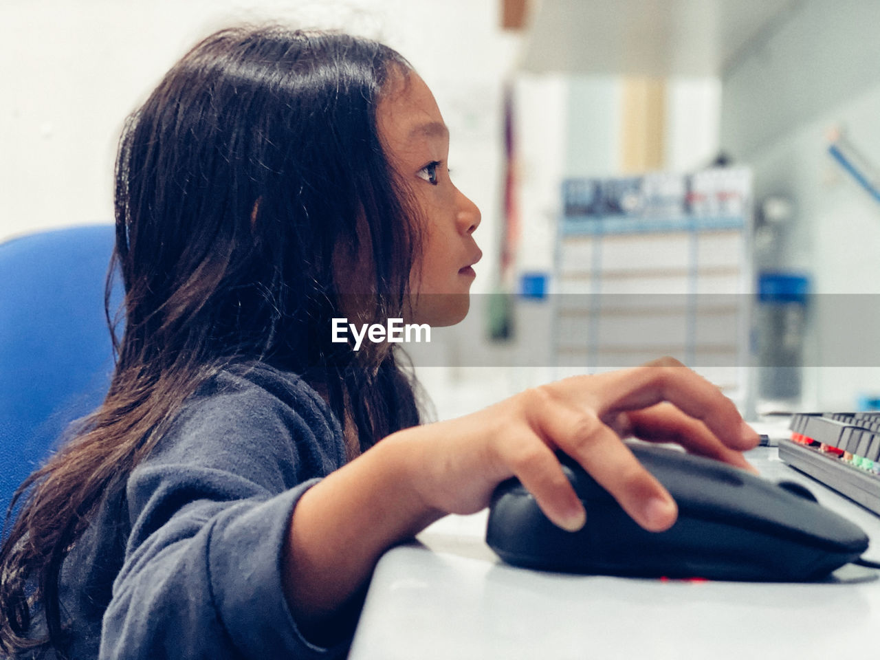 Girl using computer on table at home