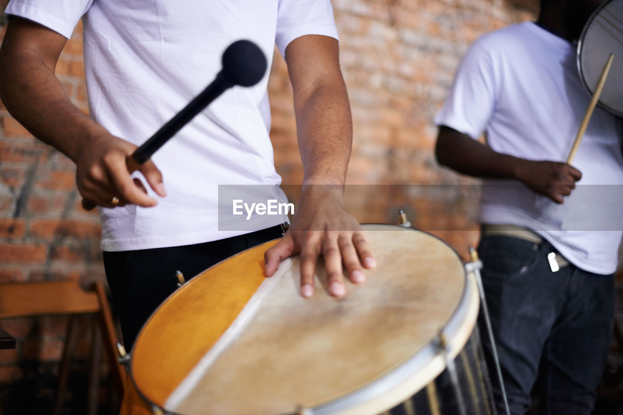 cropped image of man playing drum