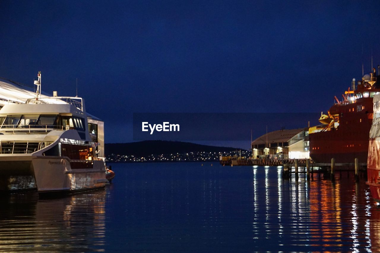 Illuminated ship by sea against sky at night