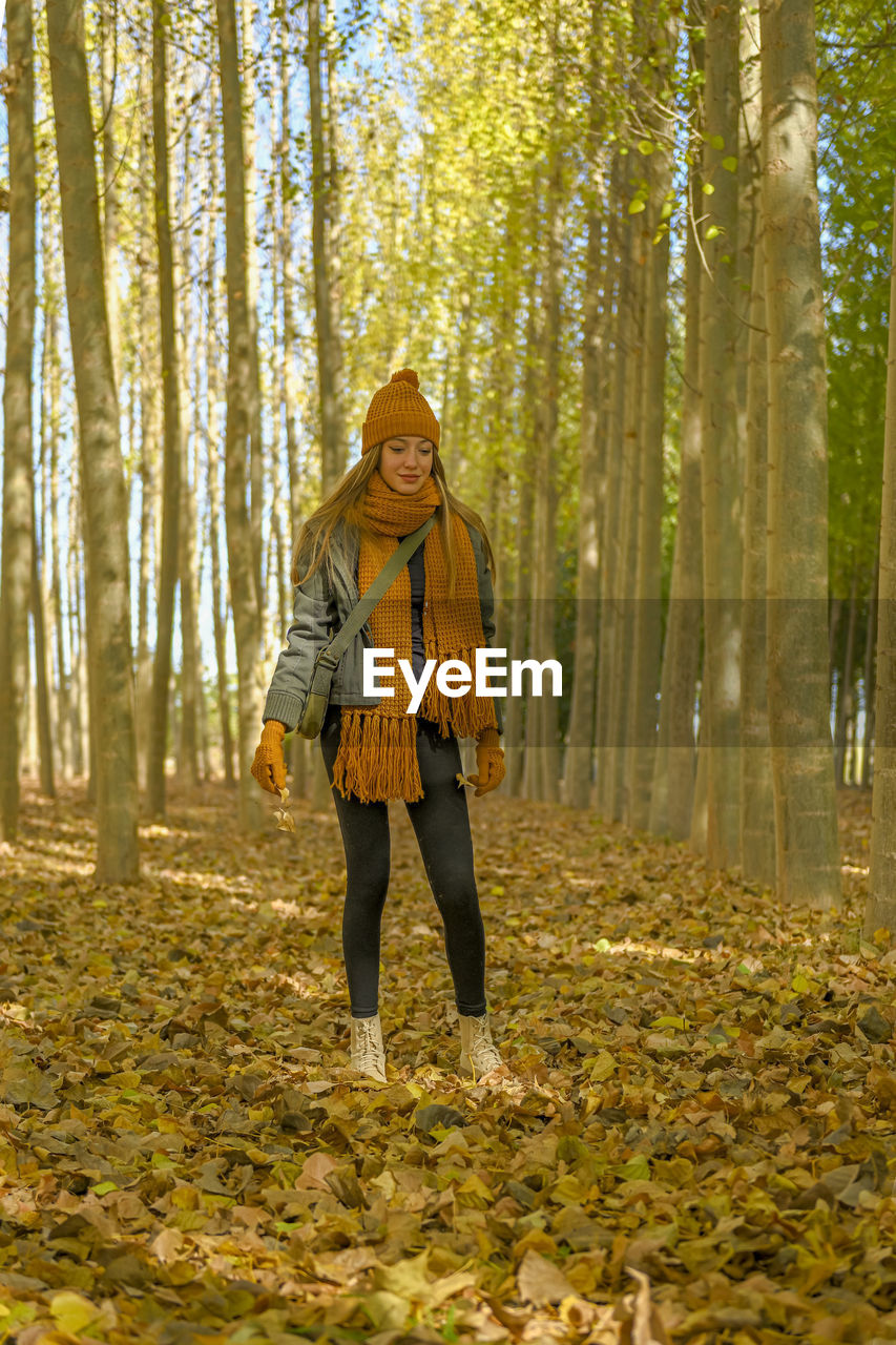 full length of woman standing in forest