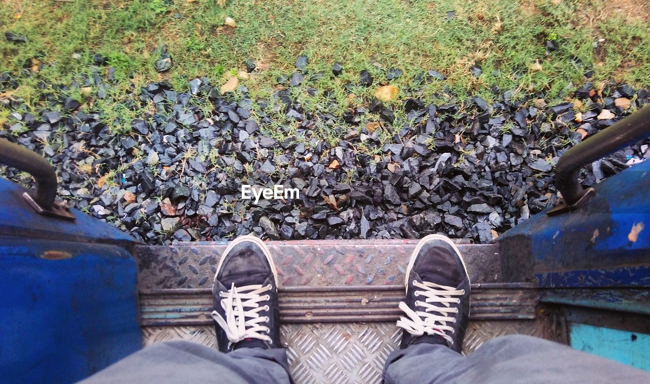 Low section of man standing in train