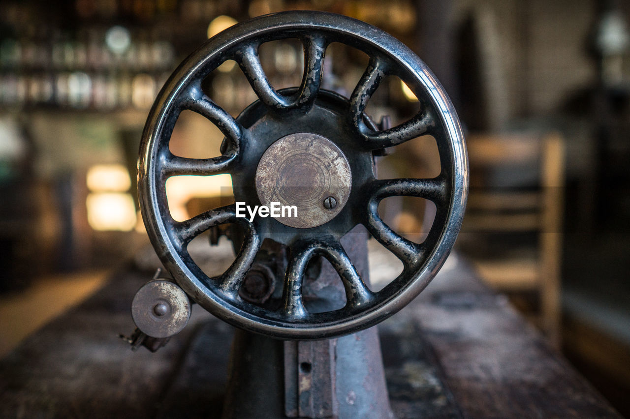 Close-up of sewing machine on table