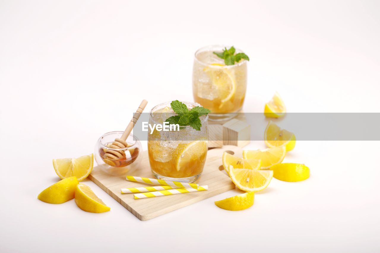 CLOSE-UP OF FRUITS AGAINST WHITE BACKGROUND WITH GRAY