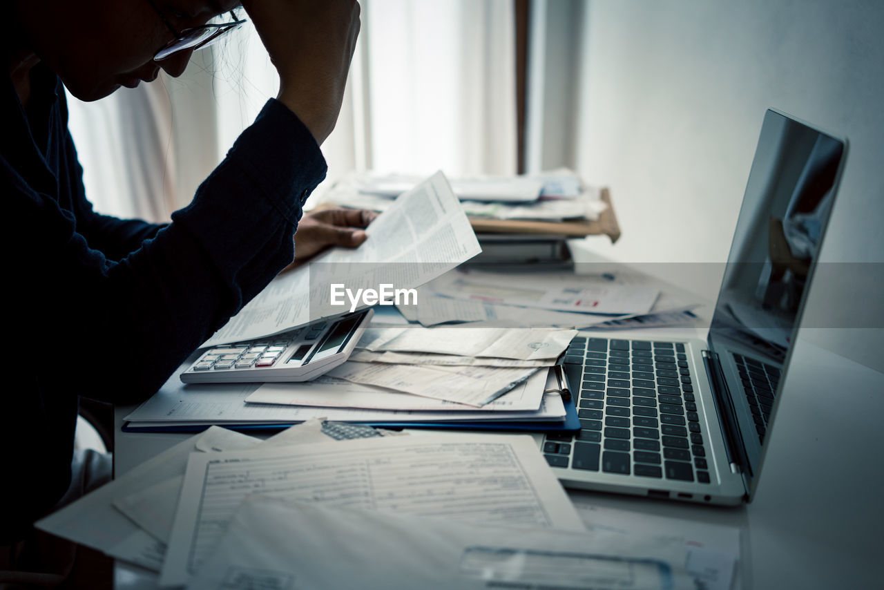 MAN WORKING ON TABLE IN OFFICE