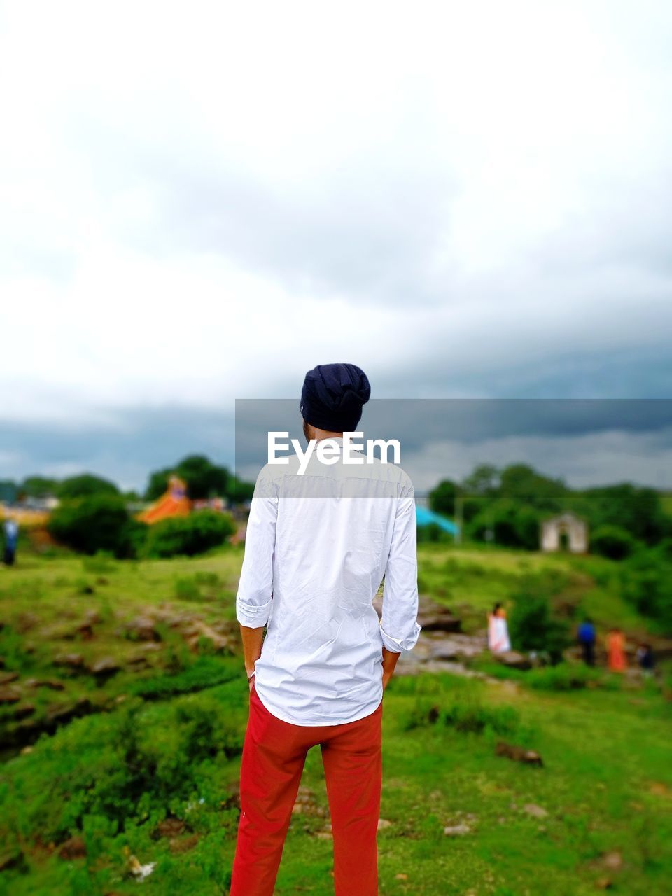 rear view, one person, sky, nature, plant, grass, standing, men, land, cloud, casual clothing, landscape, green, field, environment, adult, beauty in nature, day, leisure activity, lifestyles, outdoors, full length, rural scene, scenics - nature, non-urban scene, looking at view, person, meadow, child
