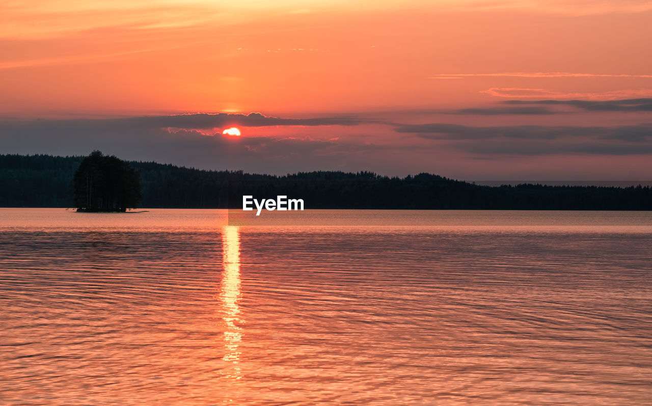 SCENIC VIEW OF LAKE AGAINST ORANGE SKY