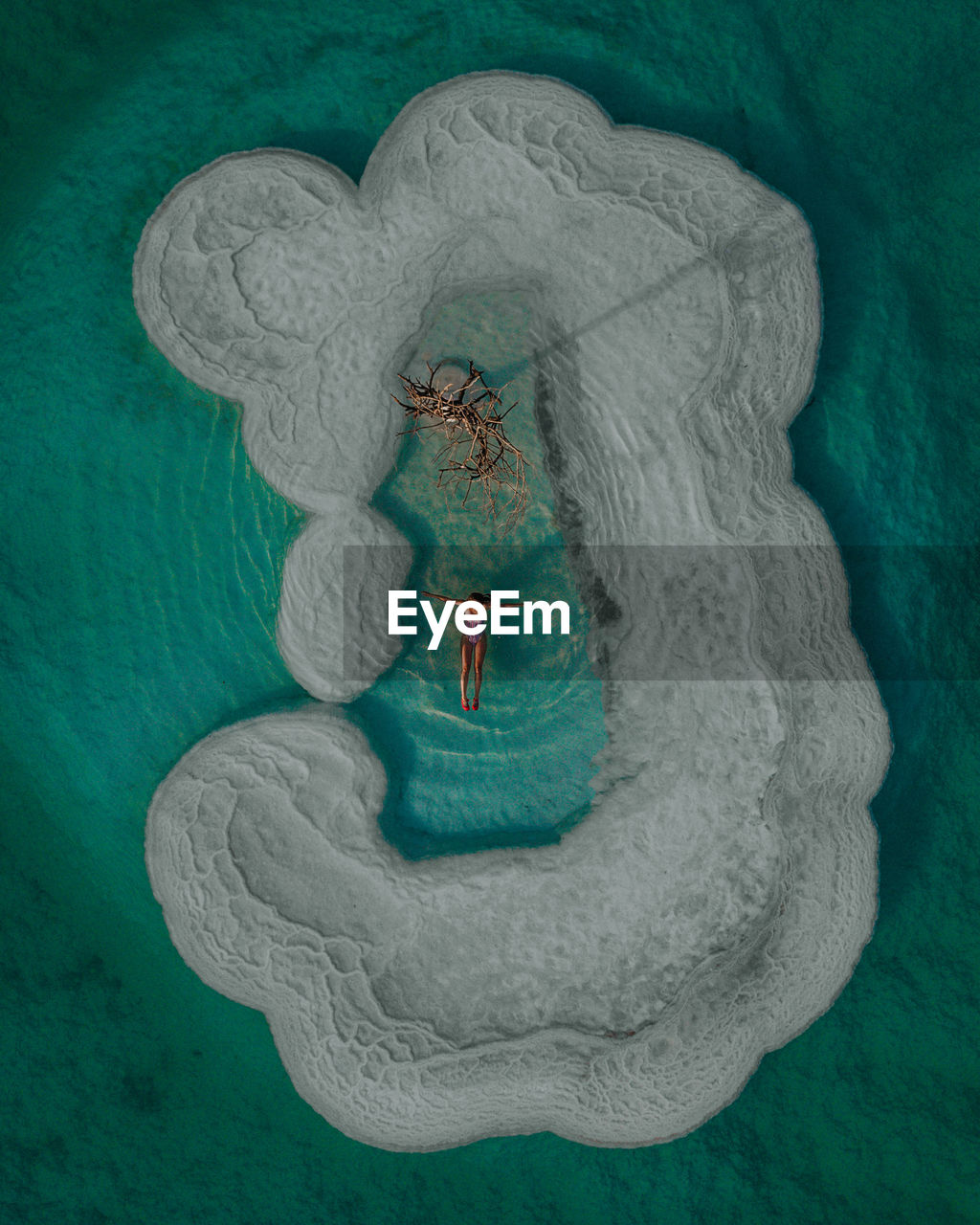 Aerial view of woman floating on sea