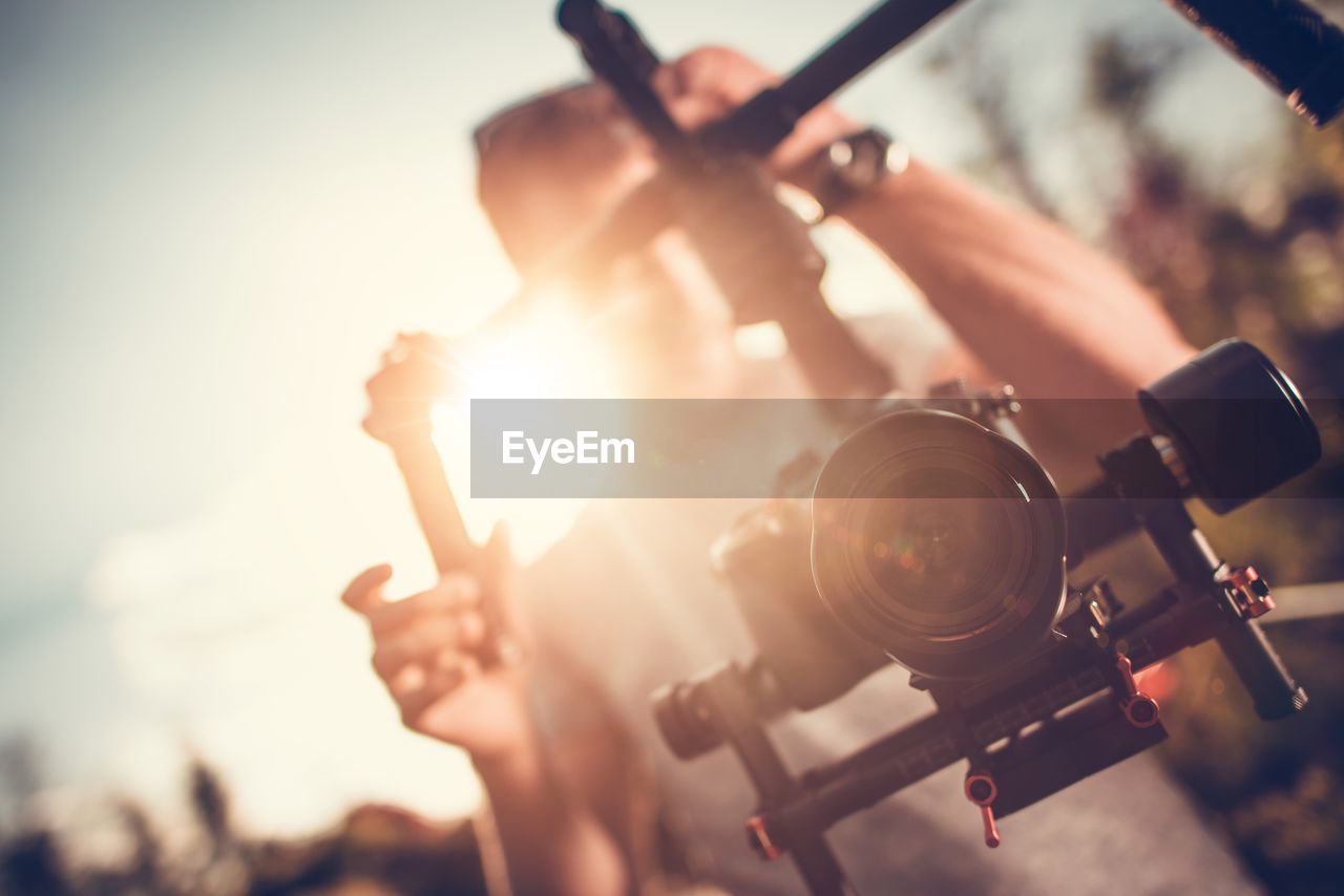 Man holding digital video camera on gimbal