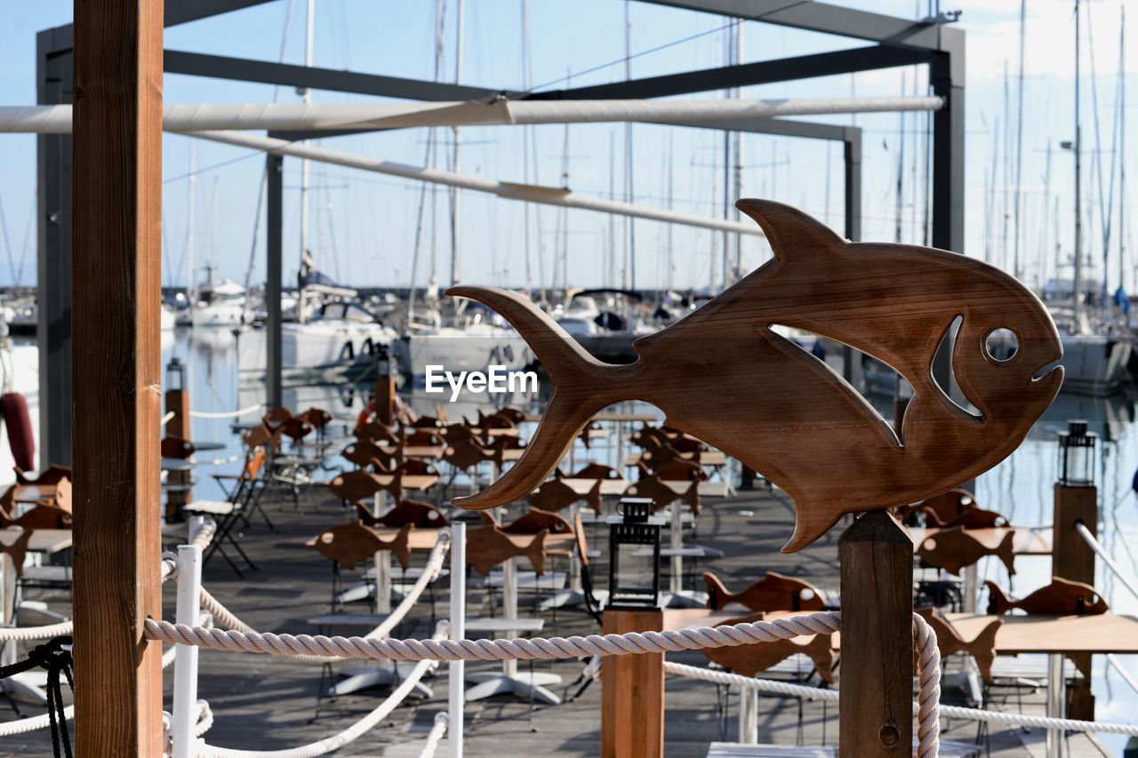 Close-up of fish decoration hanging at harbor