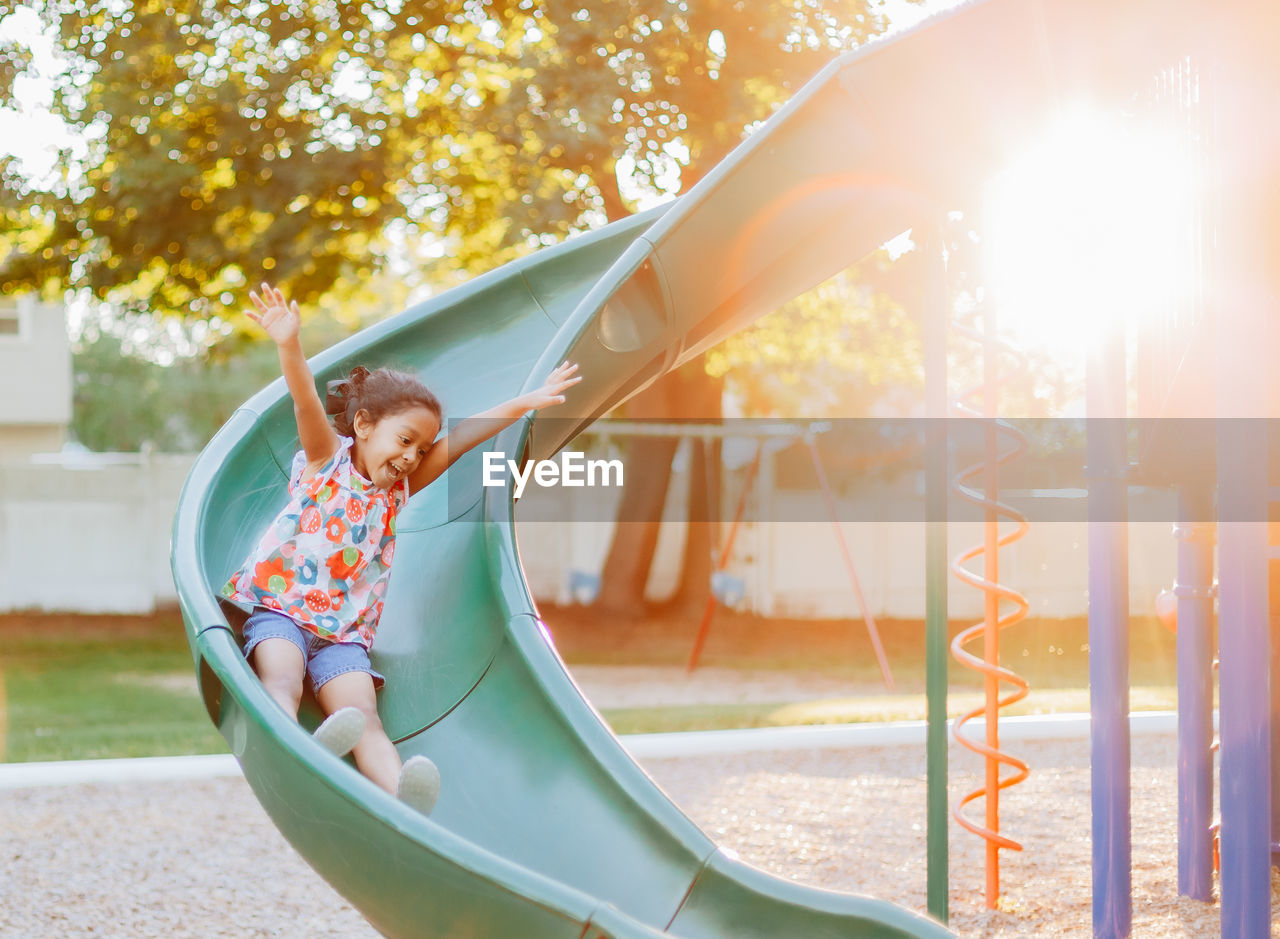 Diverse mixed race pre school age girl at park during a nice summer sunset 