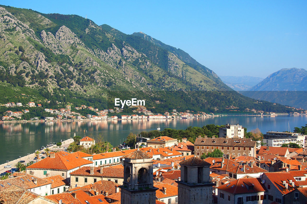 Houses by river and mountains at kotor bay