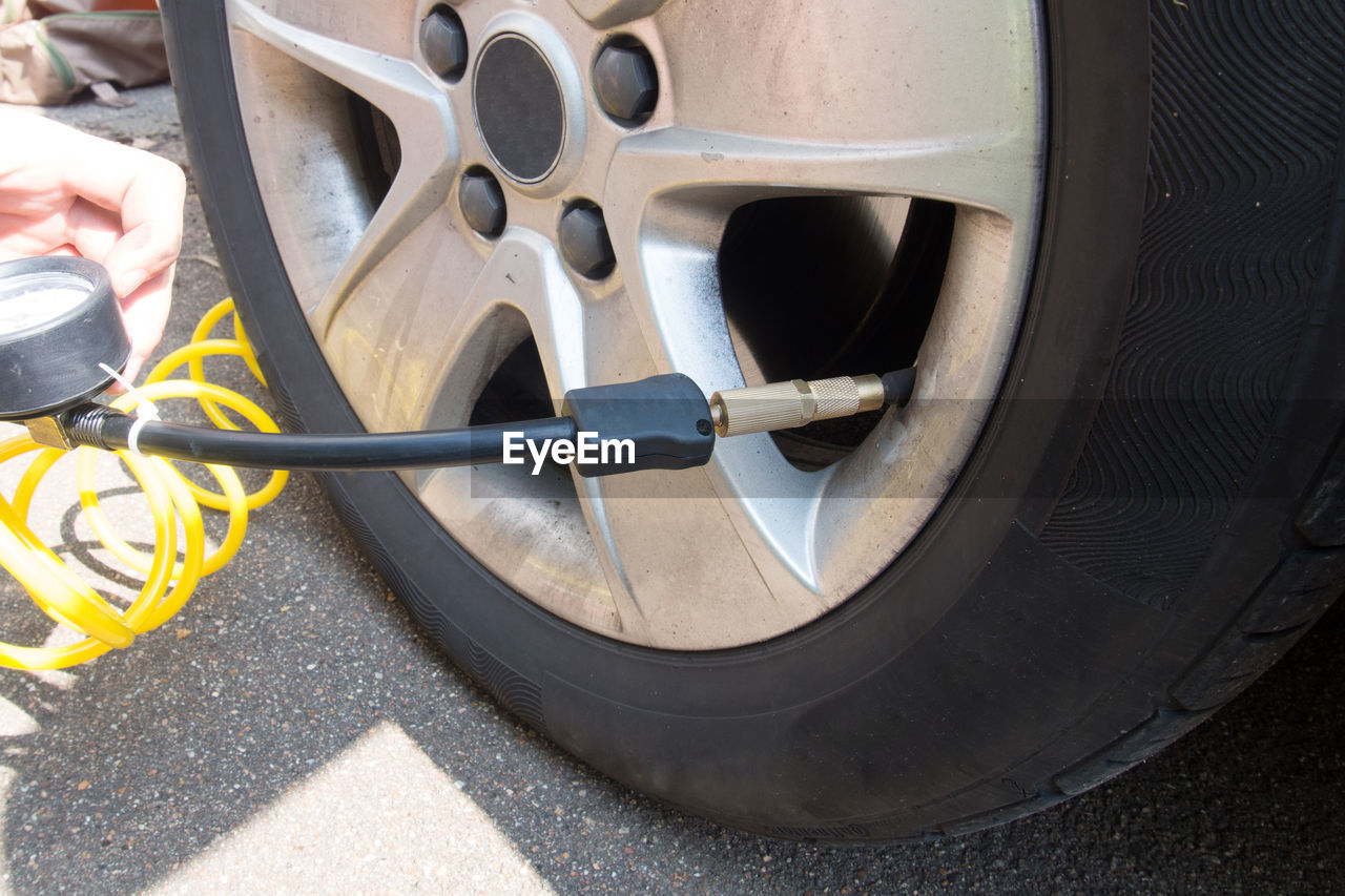 Close-up of man filling air in car