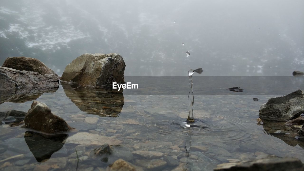 REFLECTION OF ROCKS IN SEA WATER