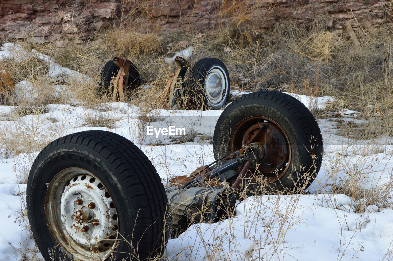 Abandoned wheels on snowy field