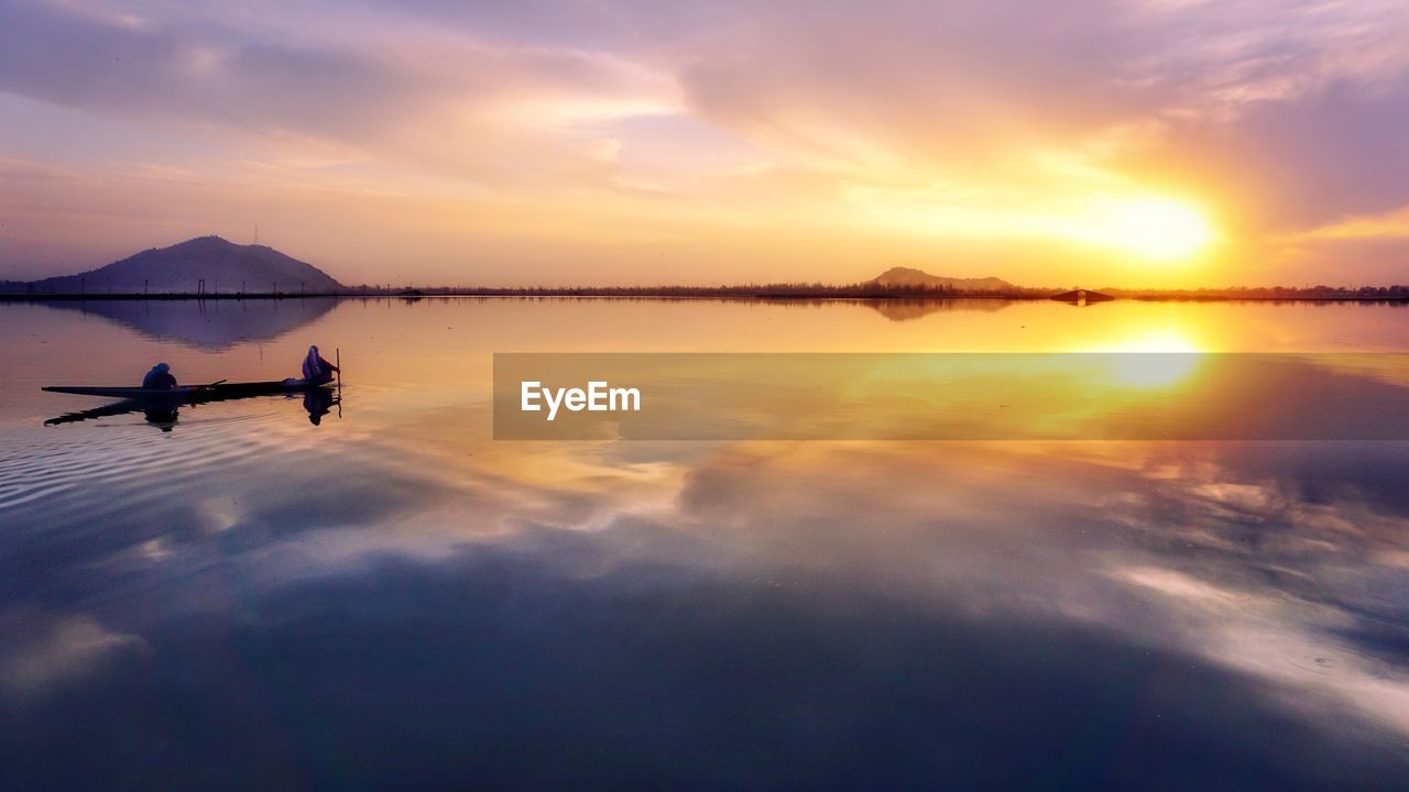 Scenic view of lake against sky during sunset