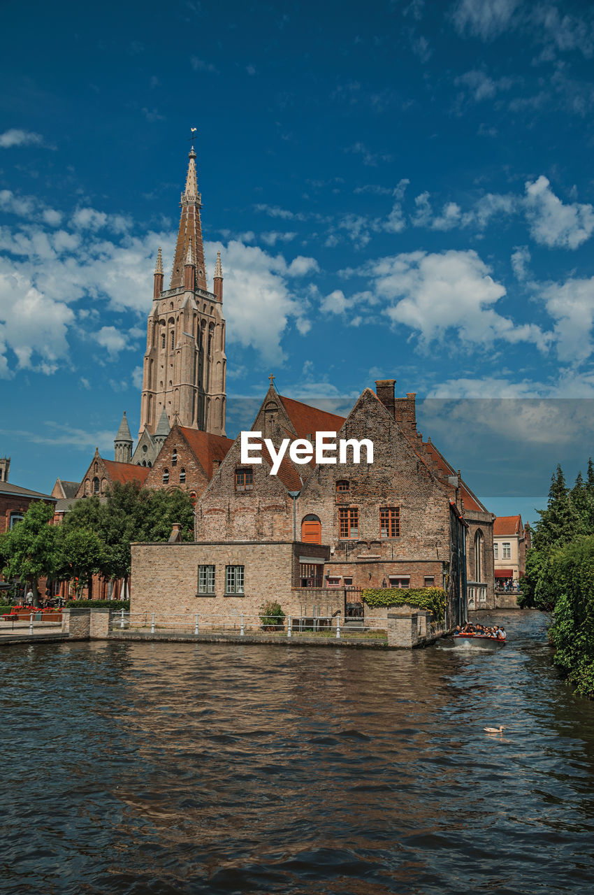 Boat and old buildings on canal of bruges. a town full of canals and old buildings in belgium.