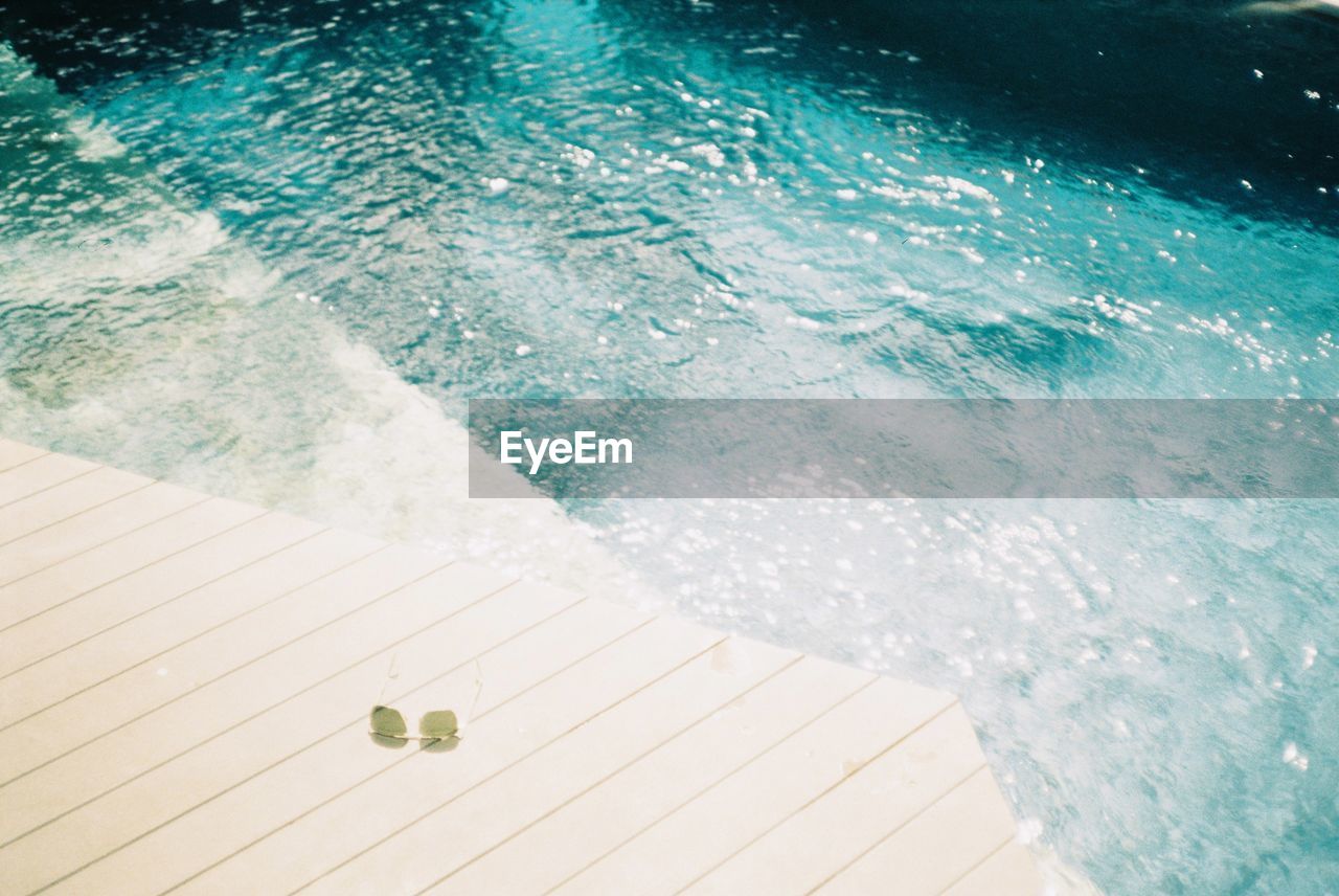 HIGH ANGLE VIEW OF SWIMMING POOL AT SEA