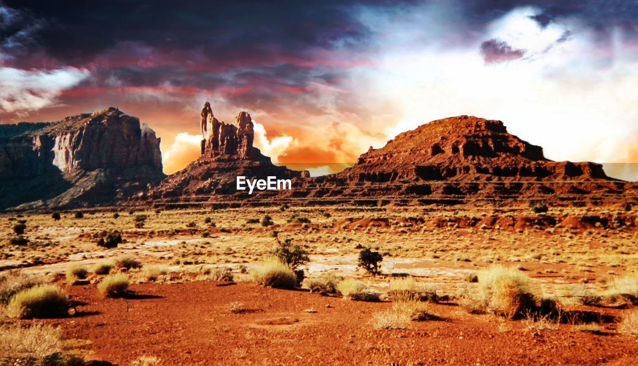 ROCK FORMATIONS ON LANDSCAPE AGAINST CLOUDY SKY