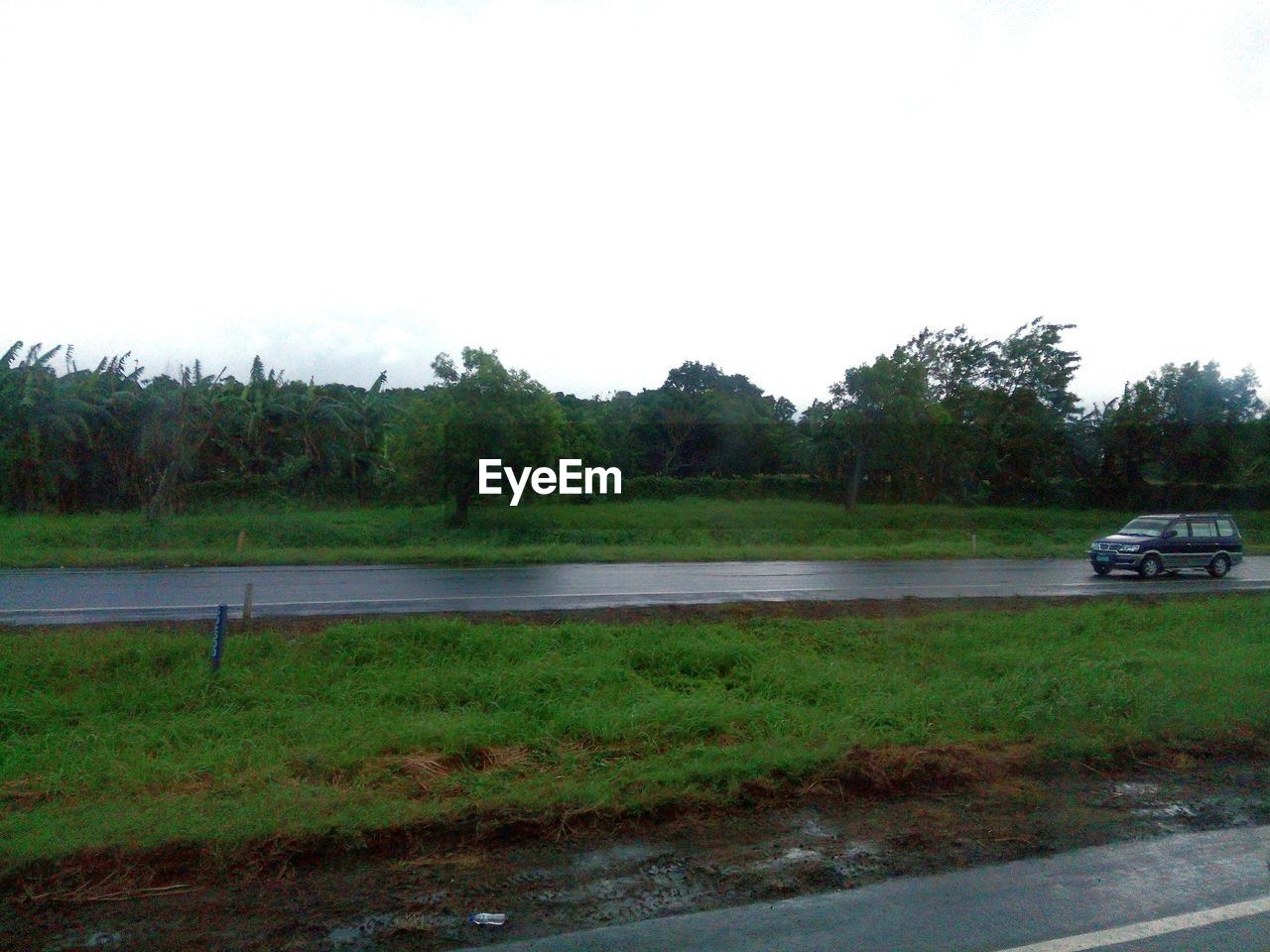 SCENIC VIEW OF FARMS AGAINST SKY