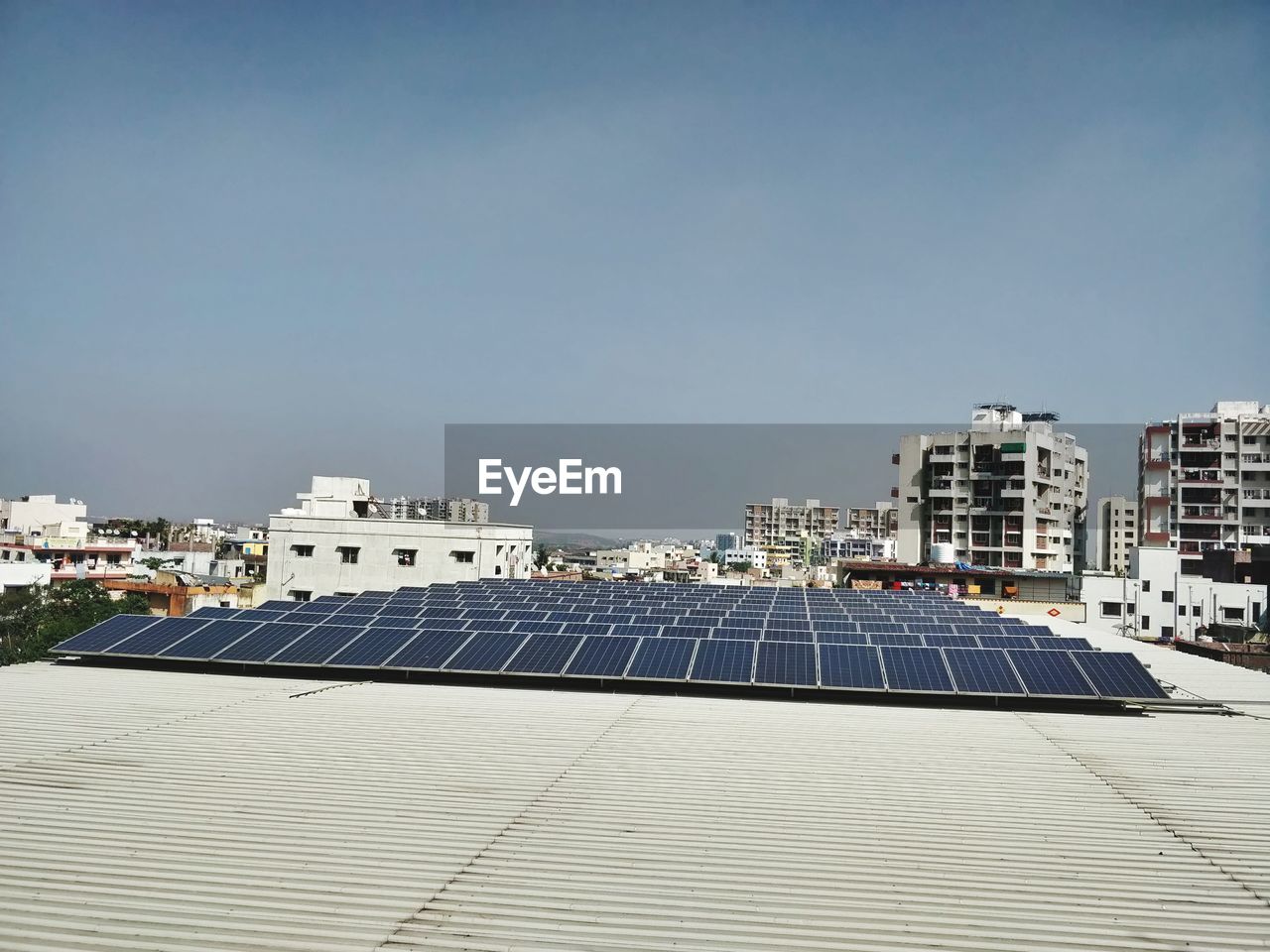 Scenic view of solar panels on residential buildings against clear sky