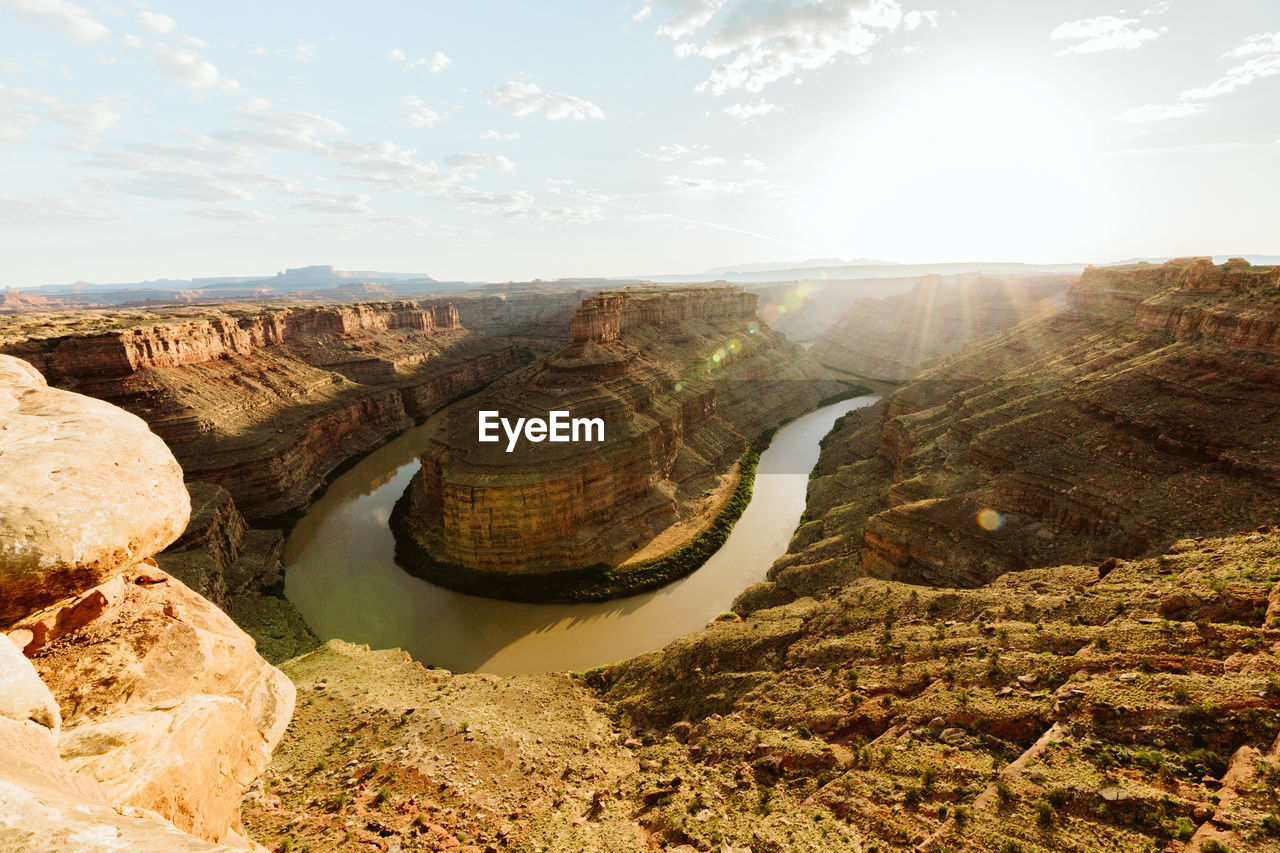 Sun shines over a big bend in the green river canyon in canyonlands