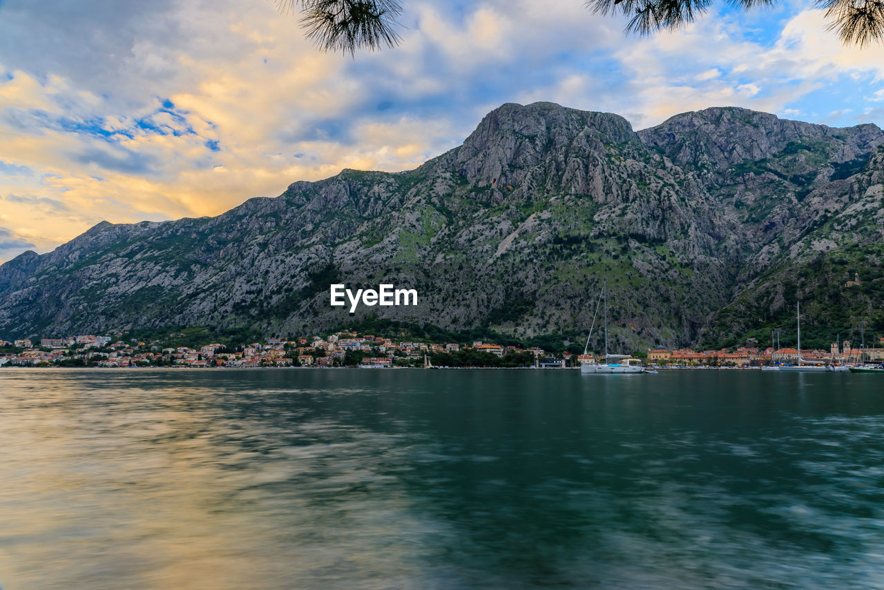 scenic view of sea and mountains against sky during sunset