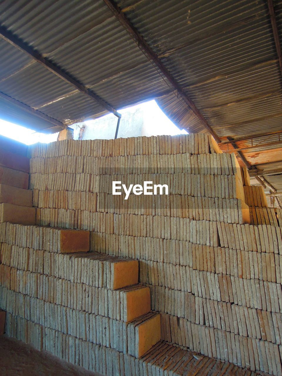 indoors, ceiling, roof beam, architecture, built structure, wood - material, low angle view, sunlight, no people, pattern, day, illuminated