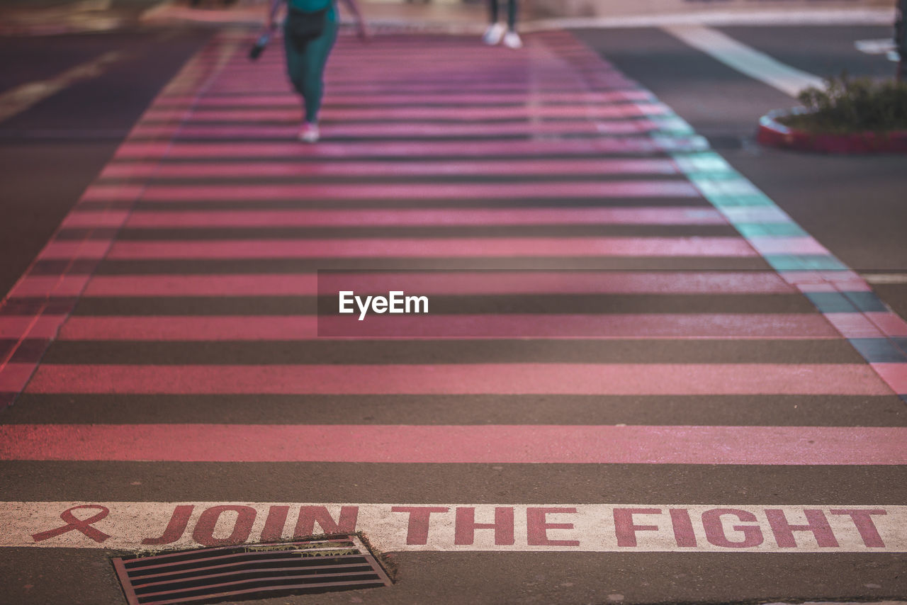 Low section of person walking on road