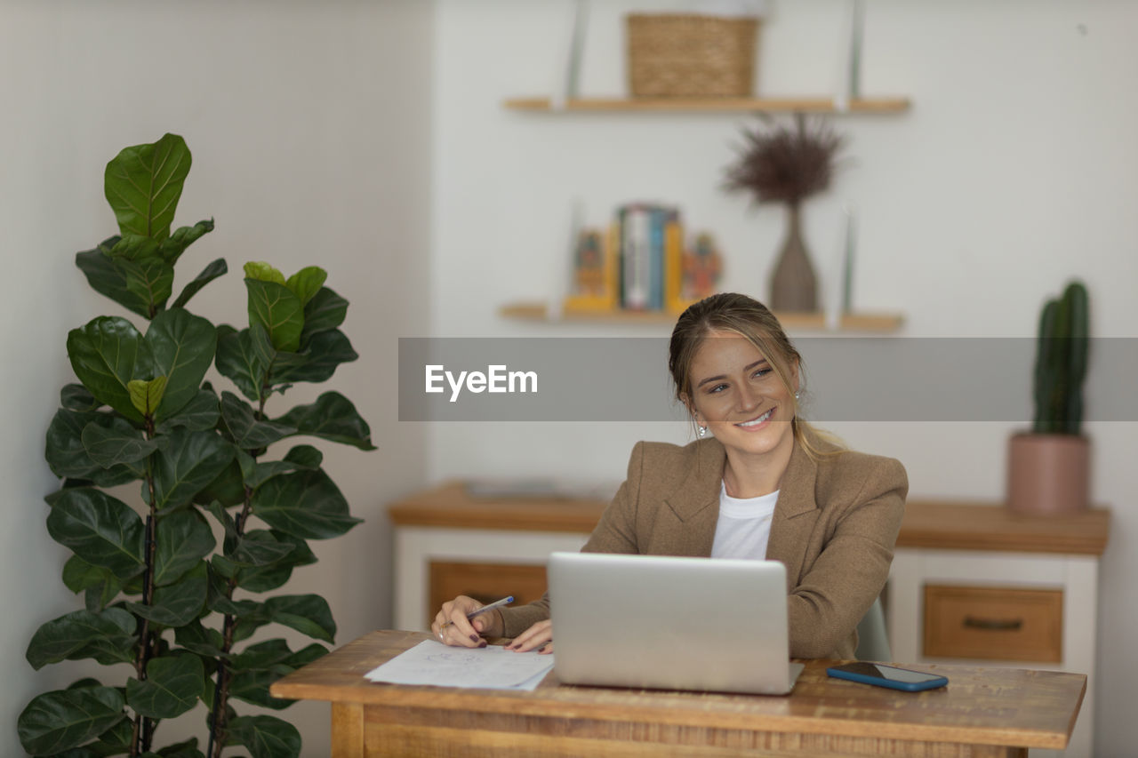 Woman working at home with laptop. home office.  notebook for working. 